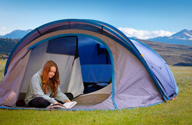 istock Girl camping in the tent 2164267224