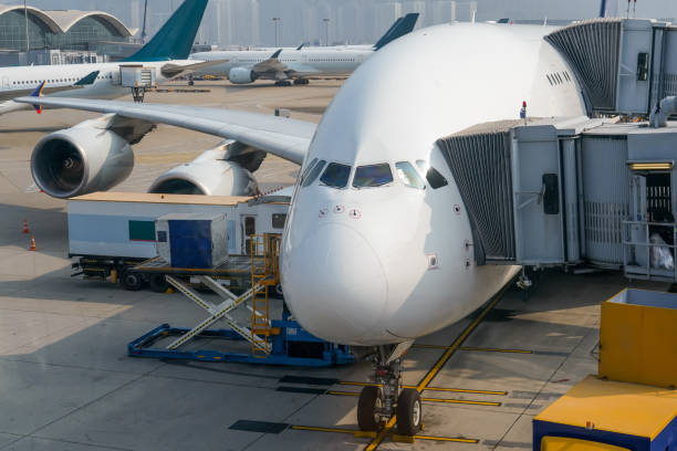 istock Huge airplane jet connected to terminal via jet bridge 2164267637