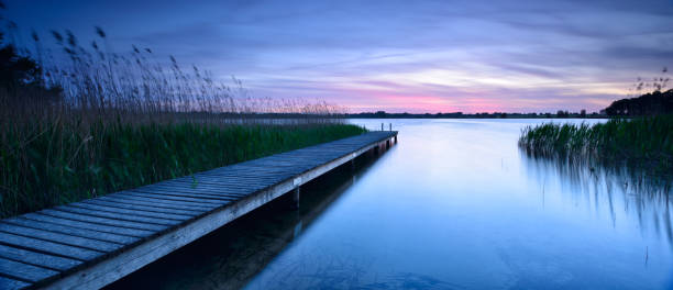 istock Lake with Wooden Pier at Sunset 2164267656
