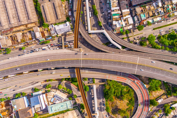 istock Aerial drone top view multi level junction interchange between highway, expressway and electric suburban train railroad in urban area 2164268834