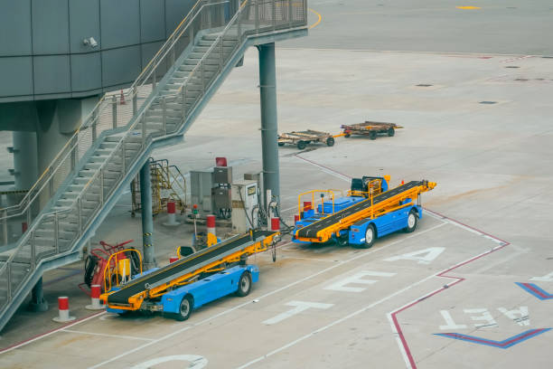 istock Equipment of a machine for loading and unloading luggage on an airplane. Serviced in preparation for boarding 2164269640