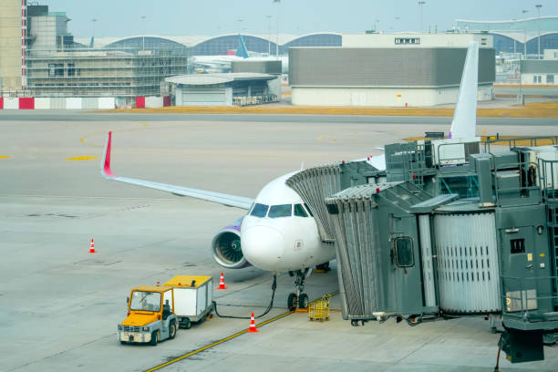 istock Airplane jet connected to terminal via jet bridge 2164269679