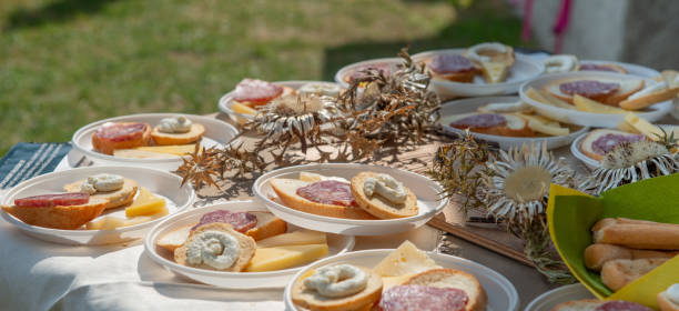 istock Table with plates of bread, cheese and salami 2164271073