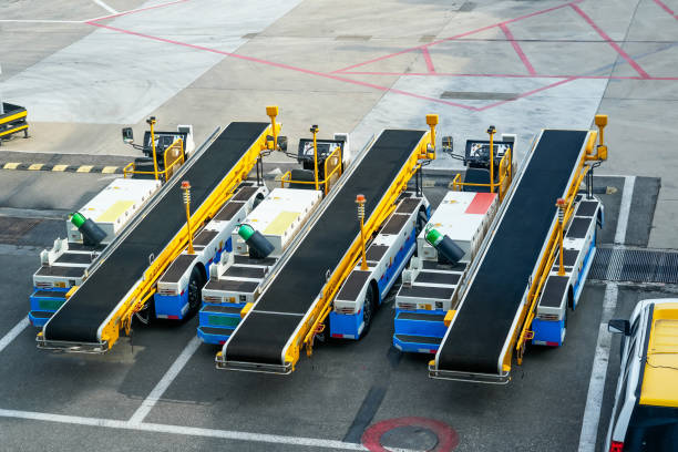 istock Equipment of three vehicle machine for loading and unloading luggage on an airplane. Serviced in preparation for boarding 2164271087
