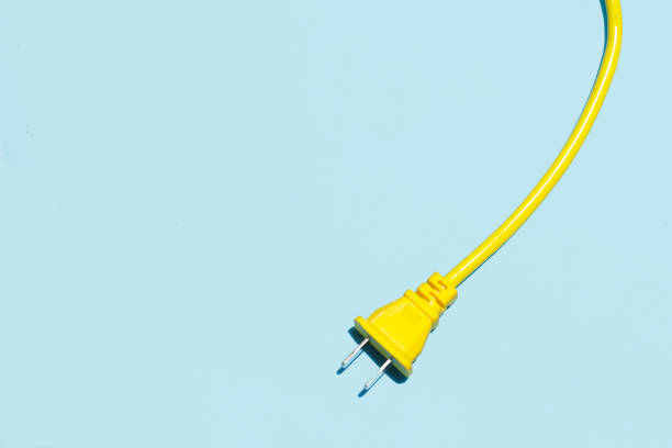 istock Yellow electric power cable with plug and socket on blue background. 2164271141