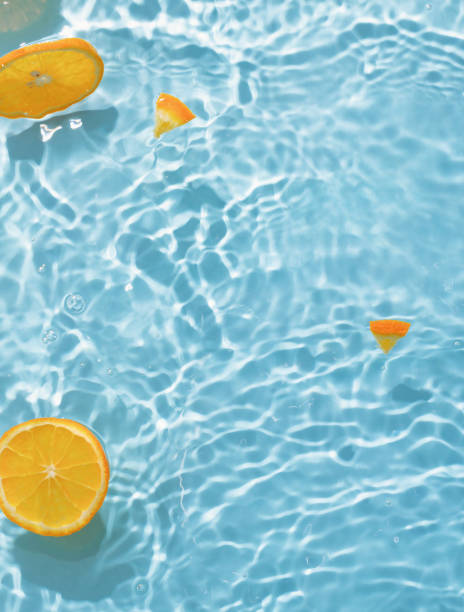 istock blue swimming pool, water texture, ripple surface and orange slices 2164273779