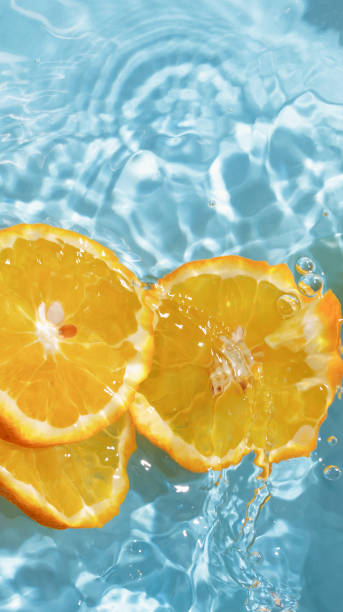 istock blue swimming pool, water texture, ripple surface and orange slices 2164273799