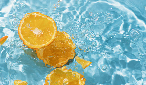 istock blue swimming pool, water texture, ripple surface and orange slices 2164273821