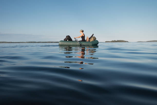 istock A female hiker floats on an inflatable boat loaded with things 2164278079