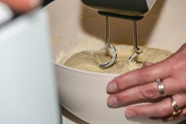 woman kneading dough with a mixer in the kitchen 11
