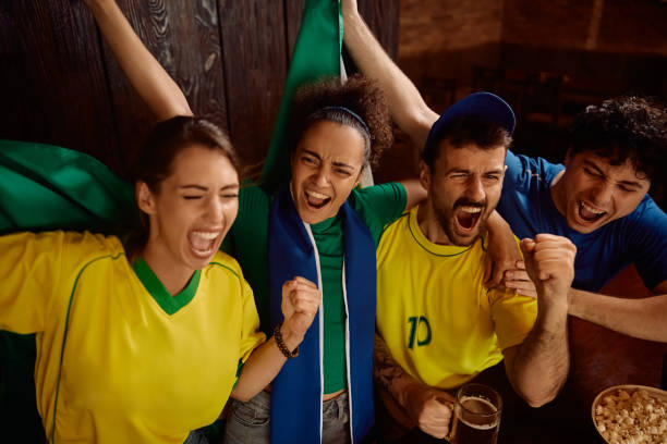 istock Group of cheerful fans having fun while celebrating in a bar. 2164279059