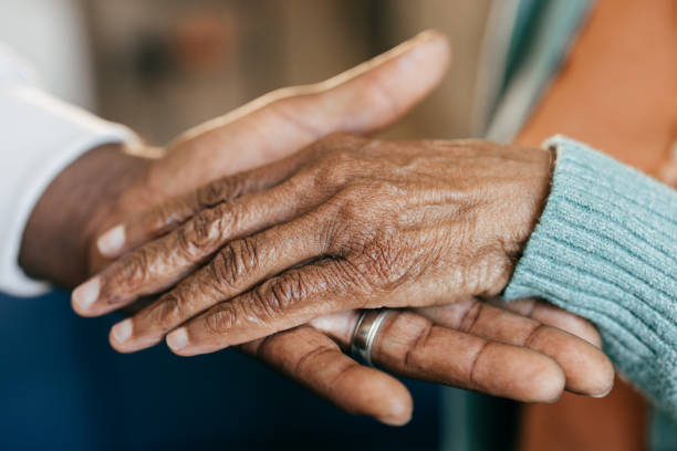 istock Young woman holding elderly hands 2164279358