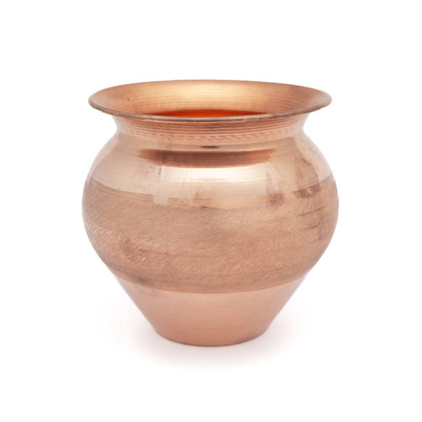 istock A copper 'Kalash' (lota), a traditional globular water container, placed on a white background. 2164284815