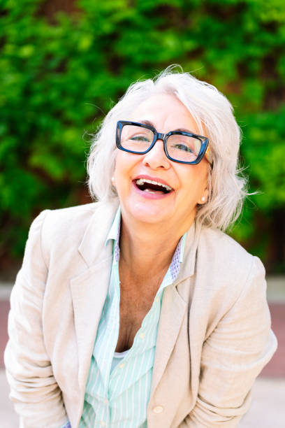 istock middle age woman laughing happy looking at camera 2164285515