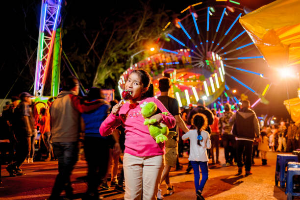 istock Young people visiting amusement park at night. 2164286852