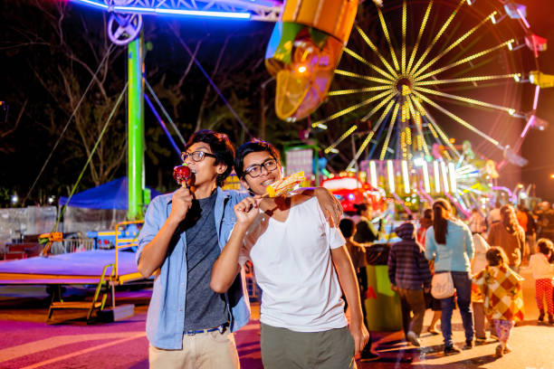 istock Young people visiting amusement park at night. 2164287049