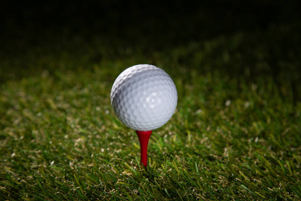 golf ball on tee in a beautiful golf course with morning sunshine. Ready for golf in the first short. Sports that people around the world play during the holidays for health.