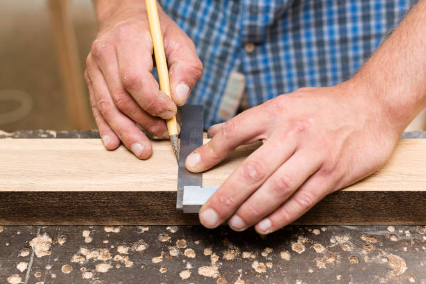 istock The carpenter measures the distance with a pencil using a square 2164291504