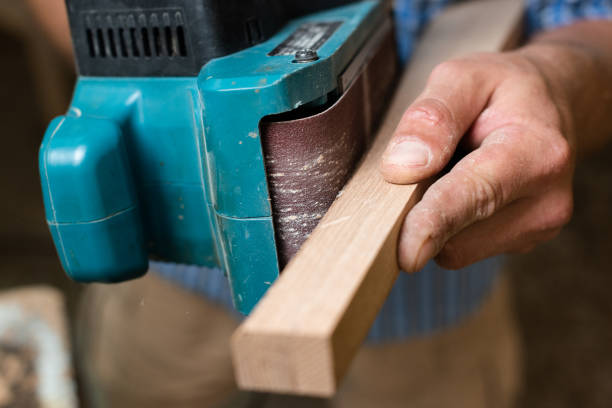 istock The carpenter grinds the part with a grinding machine 2164291507