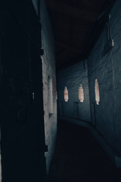 istock Dimly lit corridor with small windows in an ancient building 2164292554