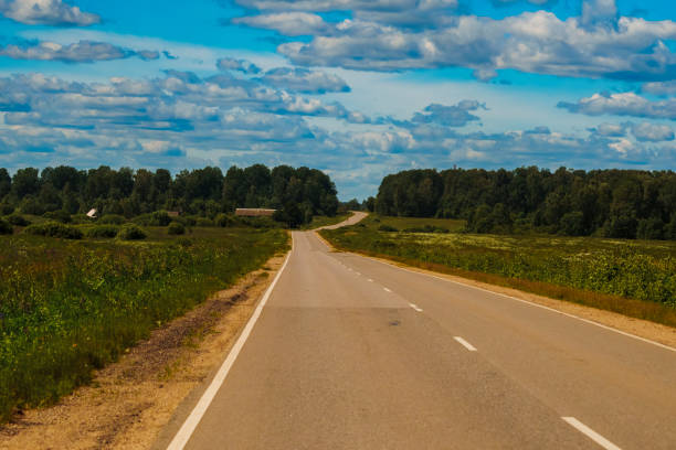 istock Empty country road with cloudy sky 2164293097