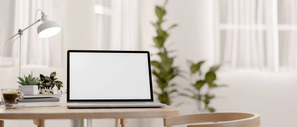 istock A laptop computer mockup on a wooden table in a bright room. indoors workspace 2164294327