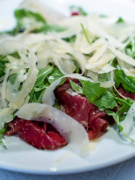 Meat Carpaccio with arugula and parmesan cheese