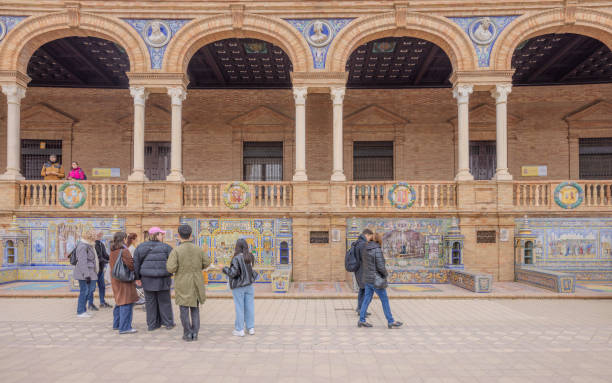 Seville, Spain - December 31, 2023:  Many visitors seen around the beautiful murals at Plaza de Espana, on New Year Eve 2023.  HDR encoded.