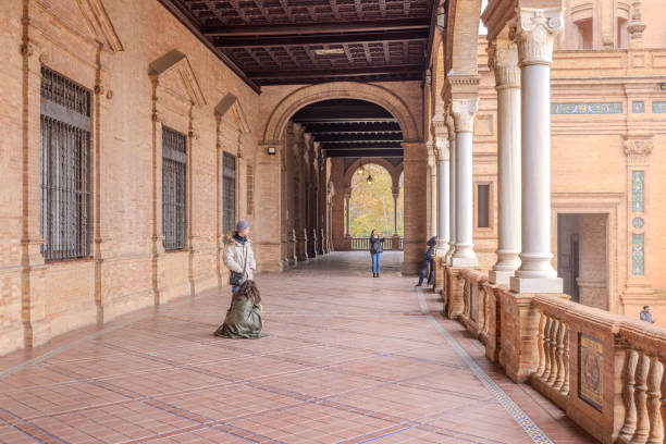 Seville, Andalusia, Spain - May 2023: Salamanca alcove at Plaza de España, Spanish Square; historic scene on colorful tiles; Text: Columb esposing his plans to the catholic kings in Salamanca