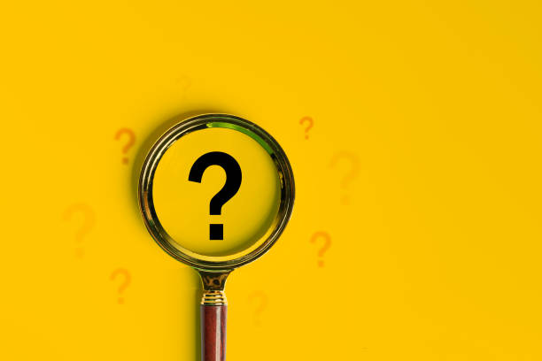 istock International ask a question day concept, Magnifying glass focused on question mark, Answer. 2164298734