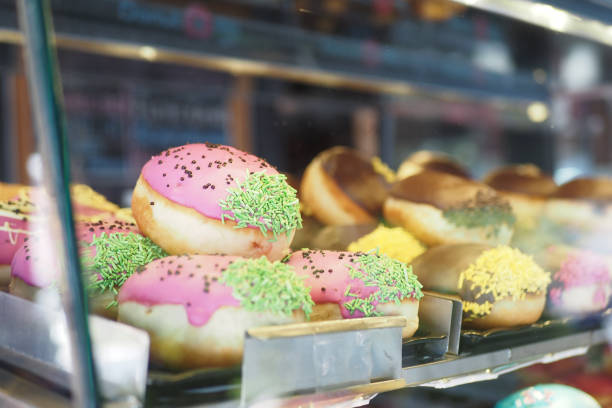istock chocolate donuts display for sale at local store 2164300172