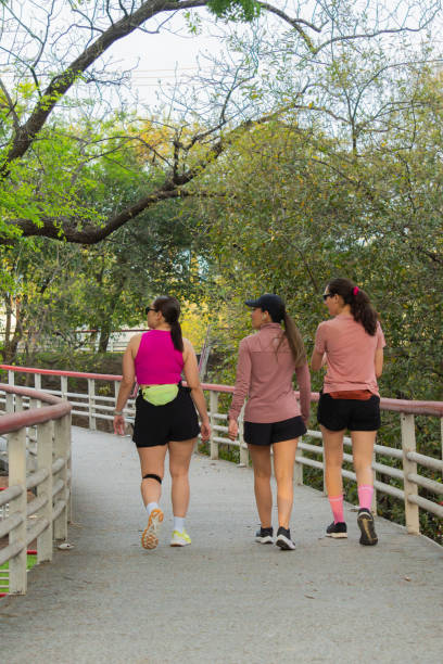 istock Latin Women Walking on Bridge in Park 2164300564