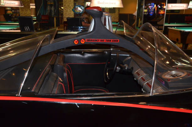 The headlights of an old classic car are on at midnight