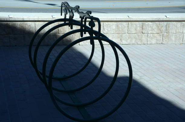 close up of an empty loop style bicycle rack, on the sidewalk in front of a brick wall, Long Island, NY