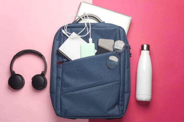 istock Laptop with Modern gadgets and accessories for work and study in Backpack on pink background. Top view. Flat lay 2164304875