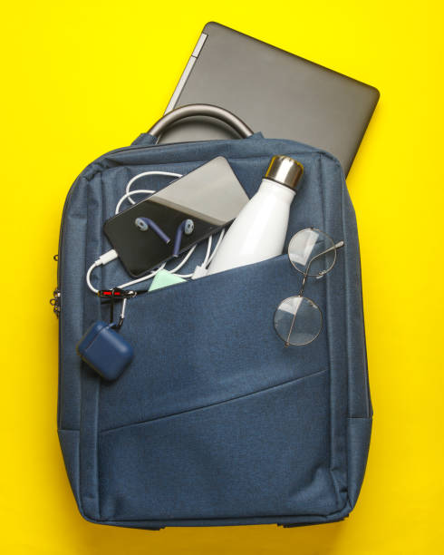 istock Modern gadgets and accessories for work and study in Backpack on yellow background. Top view. Flat lay 2164304920