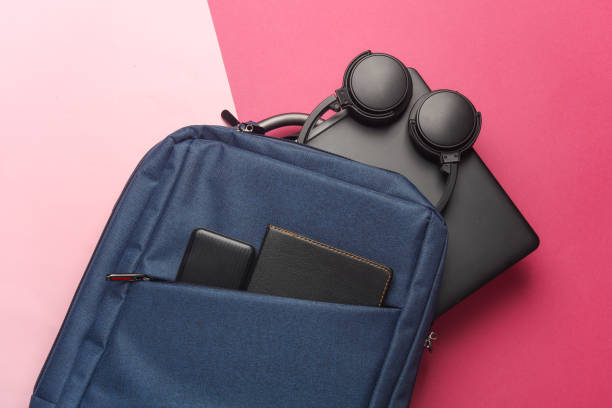 istock Laptop with Modern gadgets and accessories for work and study in Backpack on pink background. Top view. Flat lay 2164304921