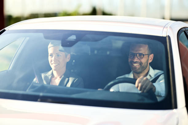 istock Happy business couple going on a trip by car. 2164304941