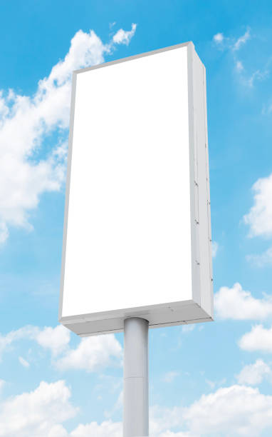 istock Mock up white vertical light box billboard on pole with blue sky background. Clipping path for mockup 2164304962