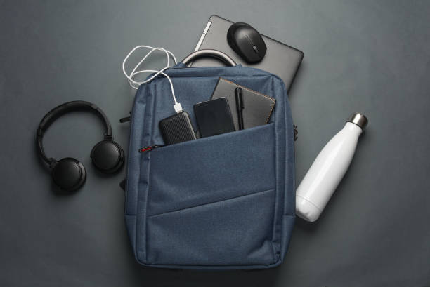 istock Laptop with Modern gadgets and accessories for work and study in Backpack on dark gray background. Top view. Flat lay 2164305016