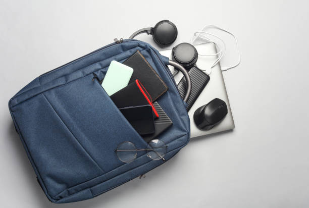 Laptop with Modern gadgets and accessories for work and study in Backpack on white background.