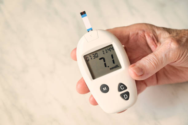 istock Elderly person checking blood sugar levels with glucometer 2164305546