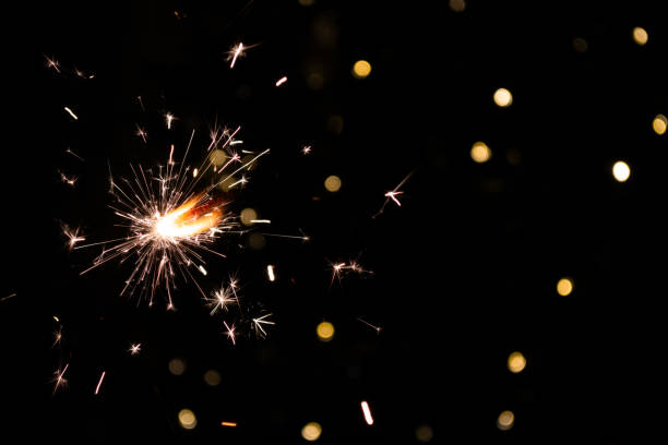 istock shiny fire sparkler on dark background 2164306537