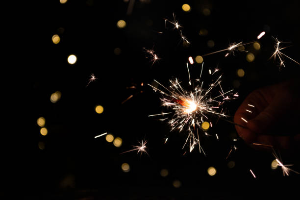istock shiny fire sparkler on dark background 2164306541