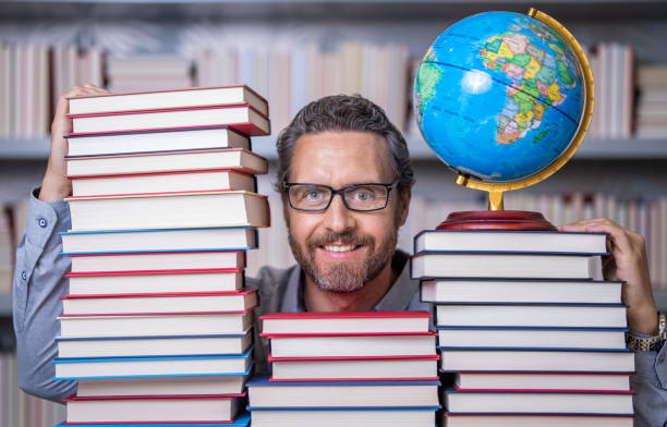 istock education in school library. man bookworm getting knowledge. teachers and knowledge day. clever school teacher. bookworm man in classroom. teacher with book literature. genius behind the masterpiece 2164309430