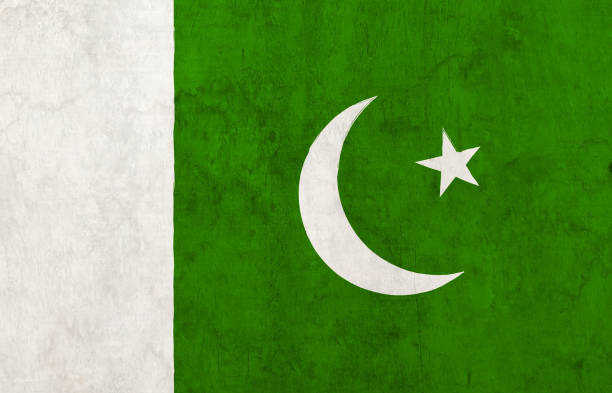 istock Pakistan Flag - Horizontal backgrounds of green and white painted whitewashed wall as in Pakistani National Flag painted as graffiti with one crescent moon and a pentagram star 2164311995