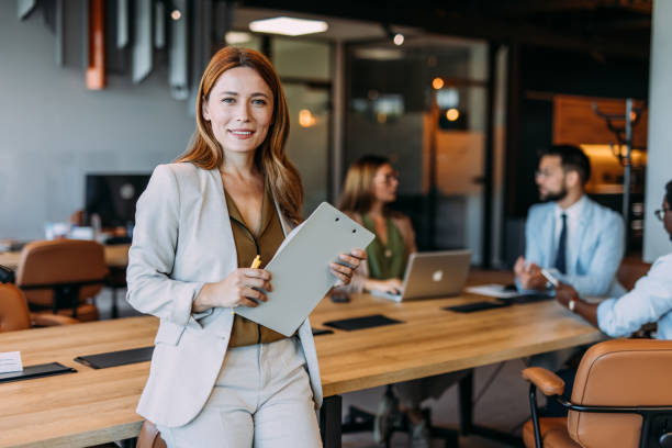 istock Confident businesswoman and her team. 2164312873
