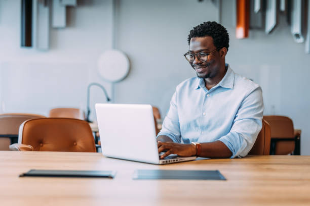 istock Successful businessman in modern office working on laptop. 2164312879