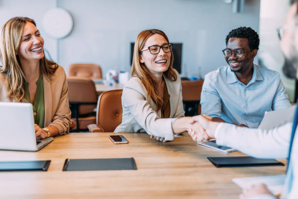 istock Businesspeople shaking hands across the table. 2164312883