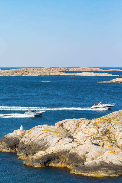 istock Motor boat in rocky sea coast 2164312908